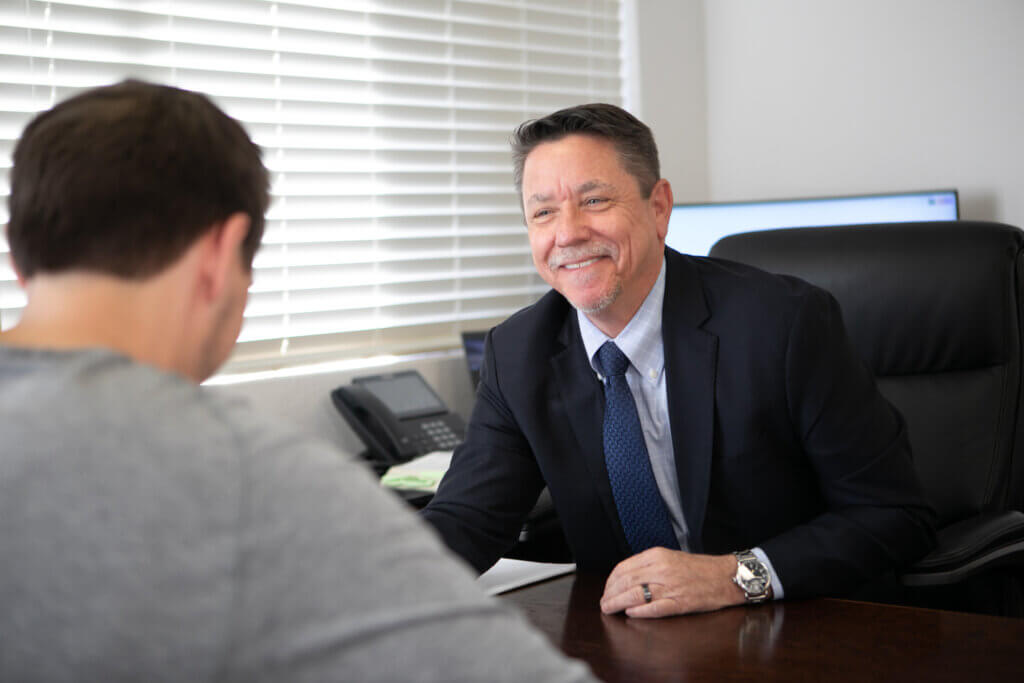 A family lawyer is offering legal advice related to divorce services to a client in his office
