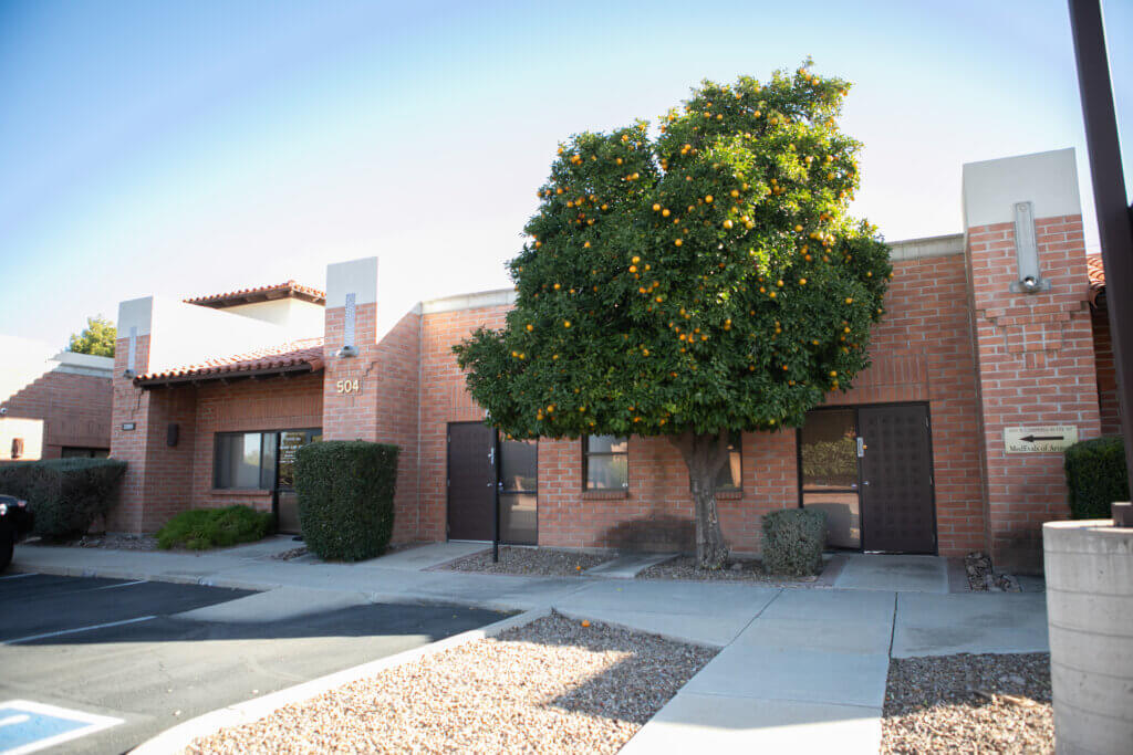 The sun is shining on the exterior of a family law office in tucson
